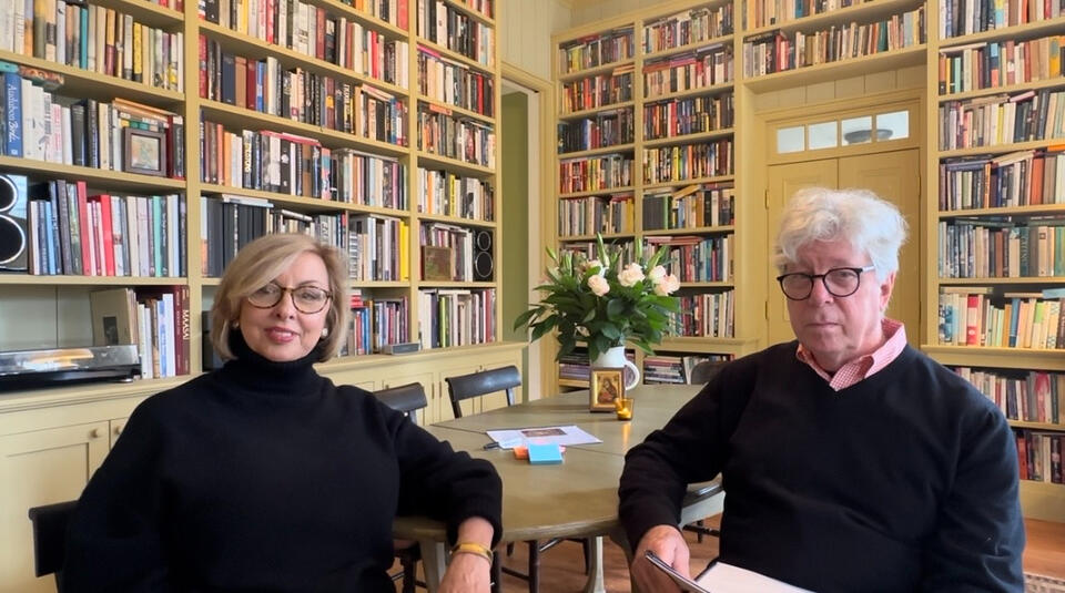 Courtney and Jim sitting at a desk